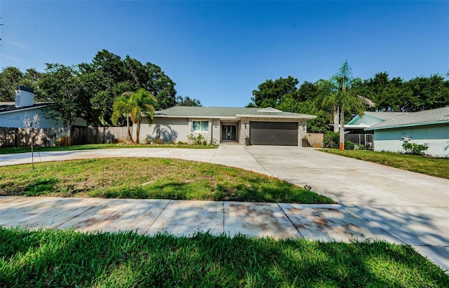 1120 Lancer Ln, Tarpon Springs, FL 34689 - ranch-style home featuring curved driveway and an attached garage