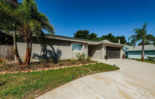 1120 Lancer Ln, Tarpon Springs, FL 34689 - view of front of property featuring an attached garage, concrete driveway, and stucco siding