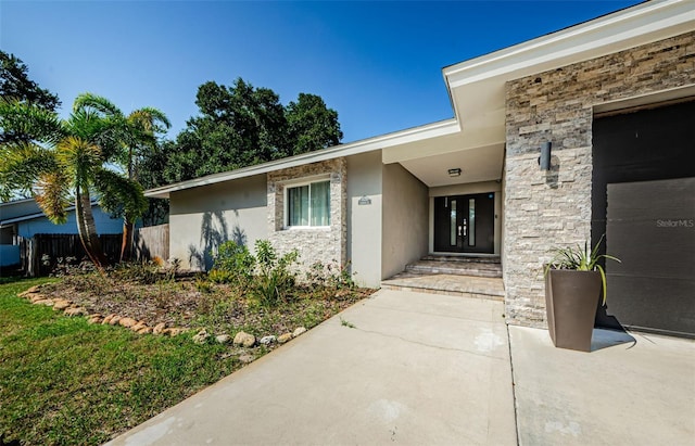 1120 Lancer Ln, Tarpon Springs, FL 34689 - doorway to property featuring stucco siding