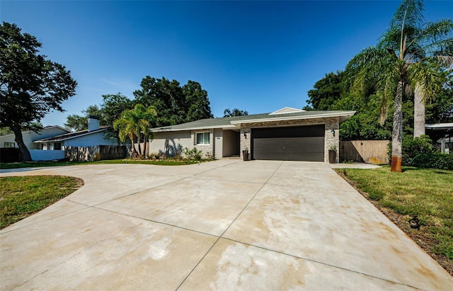 1120 Lancer Ln, Tarpon Springs, FL 34689 - ranch-style house with concrete driveway and an attached garage