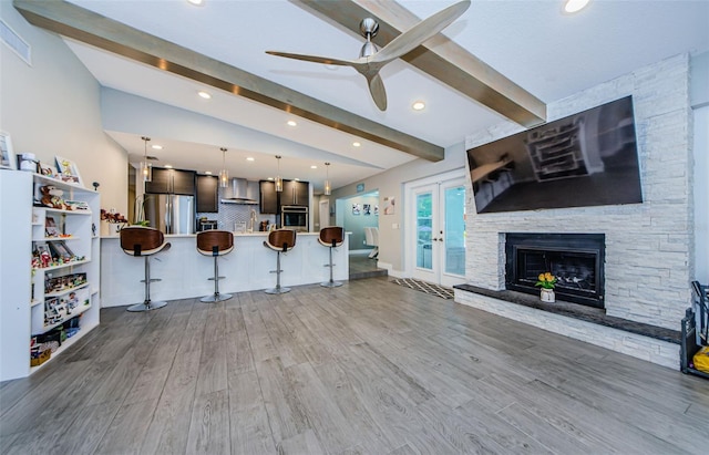 1120 Lancer Ln, Tarpon Springs, FL 34689 - kitchen featuring stainless steel appliances, wall chimney range hood, open floor plan, a breakfast bar area, and a ceiling fan