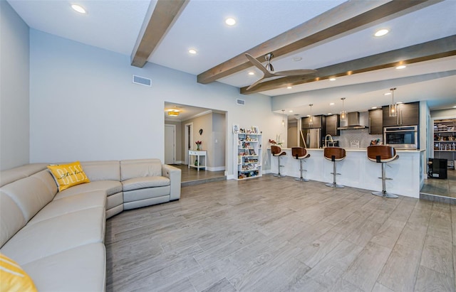 1120 Lancer Ln, Tarpon Springs, FL 34689 - living area featuring beamed ceiling, recessed lighting, light wood-style floors, and ceiling fan