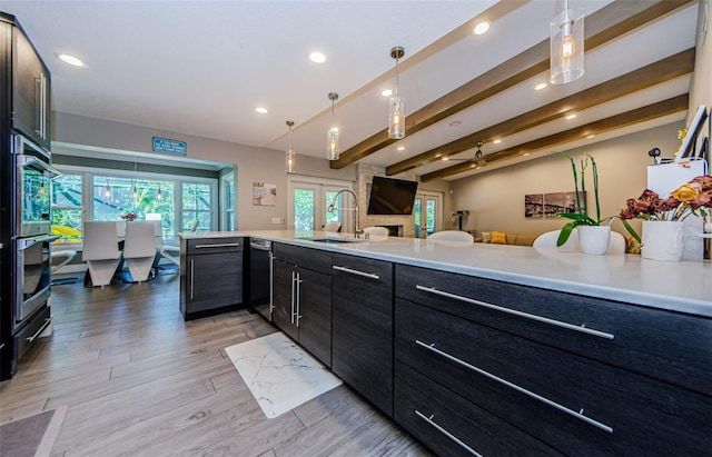 1120 Lancer Ln, Tarpon Springs, FL 34689 - kitchen with recessed lighting, light countertops, open floor plan, french doors, and hanging light fixtures