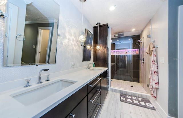1120 Lancer Ln, Tarpon Springs, FL 34689 - bathroom with a textured ceiling, a shower stall, double vanity, and recessed lighting