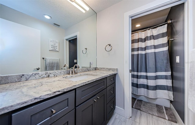 1120 Lancer Ln, Tarpon Springs, FL 34689 - bathroom featuring vanity, a textured ceiling, and a shower with curtain