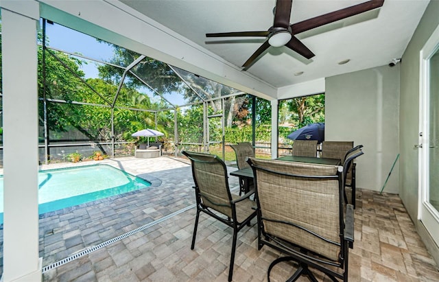 1120 Lancer Ln, Tarpon Springs, FL 34689 - swimming pool with a patio, ceiling fan, outdoor dining area, and glass enclosure