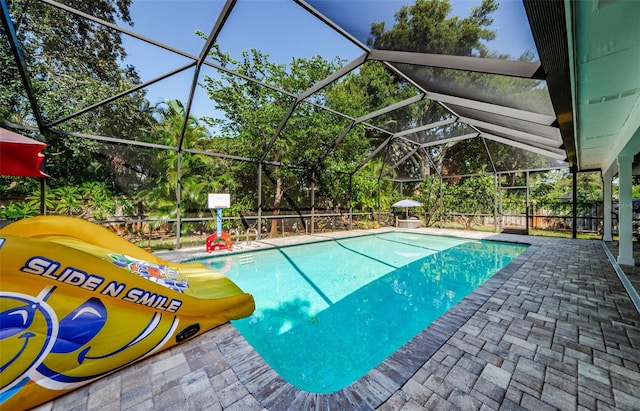 1120 Lancer Ln, Tarpon Springs, FL 34689 - outdoor pool featuring a patio area, view of wooded area, and a lanai