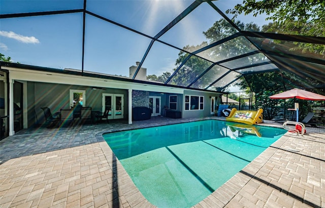 1120 Lancer Ln, Tarpon Springs, FL 34689 - outdoor pool featuring french doors, a patio, and a lanai