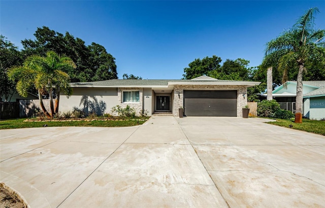 1120 Lancer Ln, Tarpon Springs, FL 34689 - ranch-style house featuring concrete driveway, a garage, and stucco siding