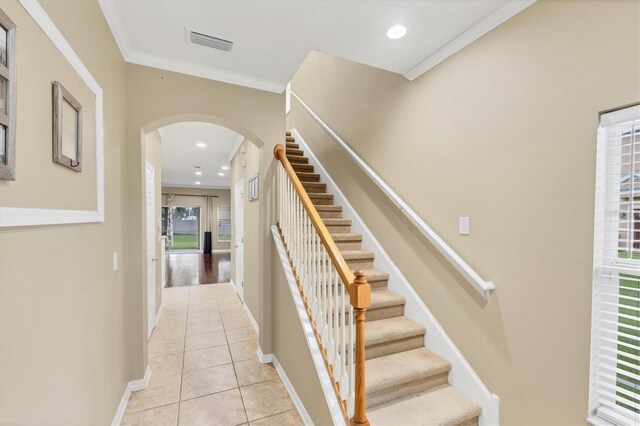 11571 84th Street Cir E Unit 106, Parrish, FL 34219 - staircase with arched walkways, tile patterned floors, recessed lighting, and ornamental molding