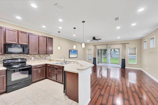 11571 84th Street Cir E Unit 106, Parrish, FL 34219 - kitchen featuring black appliances, a peninsula, open floor plan, a ceiling fan, and backsplash