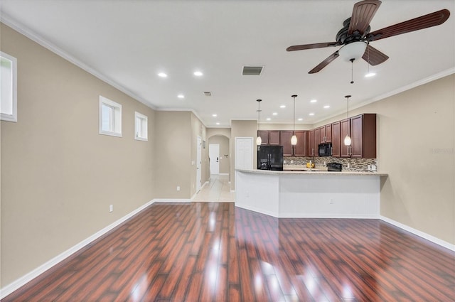 11571 84th Street Cir E Unit 106, Parrish, FL 34219 - kitchen with black appliances, a ceiling fan, crown molding, light countertops, and arched walkways