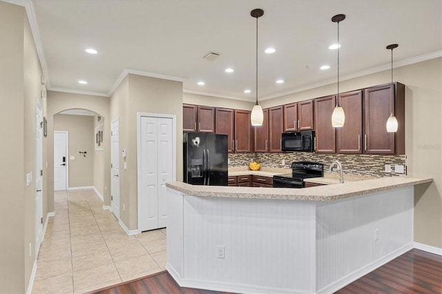 11571 84th Street Cir E Unit 106, Parrish, FL 34219 - kitchen featuring black appliances, crown molding, light countertops, arched walkways, and tasteful backsplash
