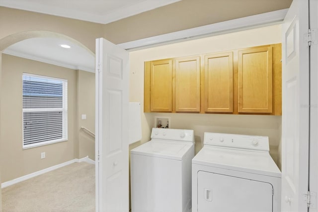 11571 84th Street Cir E Unit 106, Parrish, FL 34219 - laundry area featuring cabinet space, arched walkways, washing machine and clothes dryer, ornamental molding, and light colored carpet