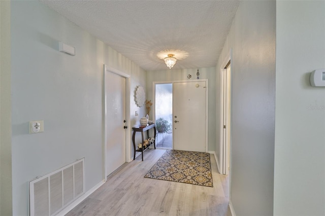 2510 Locksley St Unit 2510, Sun City Center, FL 33573 - foyer with light wood finished floors and a textured ceiling