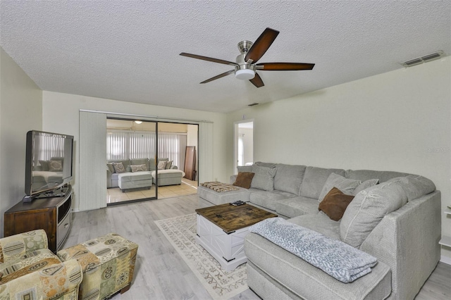 2510 Locksley St Unit 2510, Sun City Center, FL 33573 - living area featuring a ceiling fan, wood finished floors, and a textured ceiling