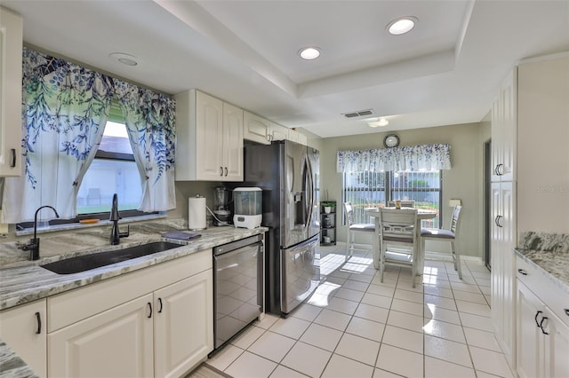 2510 Locksley St Unit 2510, Sun City Center, FL 33573 - kitchen featuring dishwashing machine, stainless steel fridge with ice dispenser, healthy amount of natural light, a tray ceiling, and recessed lighting