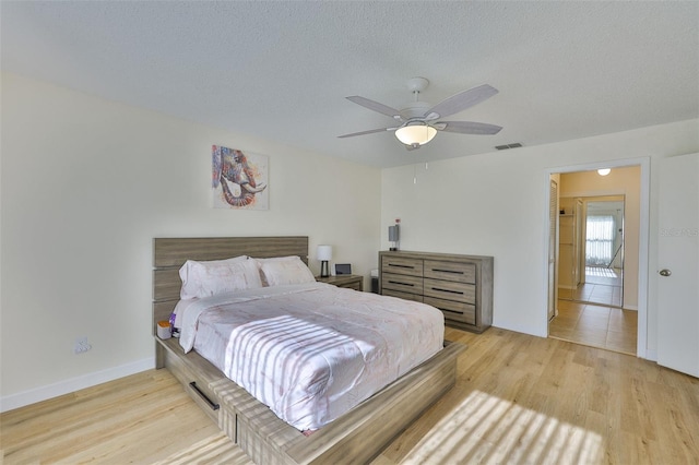 2510 Locksley St Unit 2510, Sun City Center, FL 33573 - bedroom with light wood-style flooring, a ceiling fan, and a textured ceiling