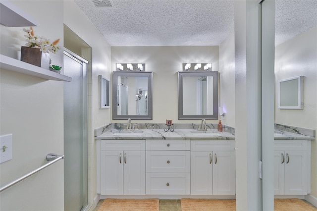 2510 Locksley St Unit 2510, Sun City Center, FL 33573 - full bathroom featuring a textured ceiling, double vanity, and an enclosed shower