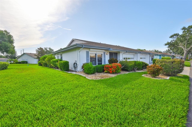 2510 Locksley St Unit 2510, Sun City Center, FL 33573 - view of side of home featuring stucco siding, a yard, and an attached garage