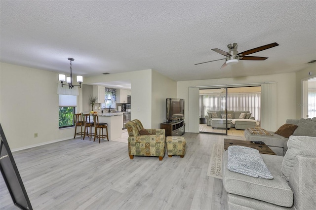 2510 Locksley St Unit 2510, Sun City Center, FL 33573 - living area featuring healthy amount of natural light, light wood-type flooring, a ceiling fan, and a textured ceiling