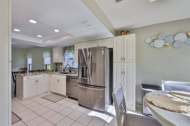 2510 Locksley St Unit 2510, Sun City Center, FL 33573 - kitchen with stainless steel appliances, recessed lighting, a peninsula, white cabinets, and light tile patterned floors