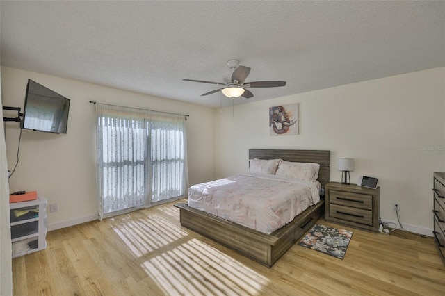 2510 Locksley St Unit 2510, Sun City Center, FL 33573 - bedroom featuring light wood finished floors, a textured ceiling, and ceiling fan