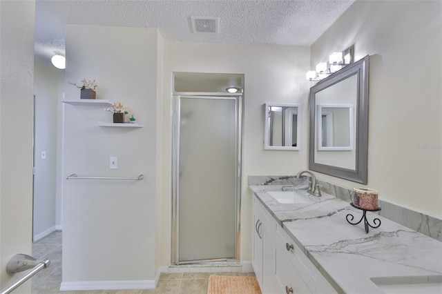2510 Locksley St Unit 2510, Sun City Center, FL 33573 - bathroom featuring a stall shower, vanity, a textured ceiling, and tile patterned floors
