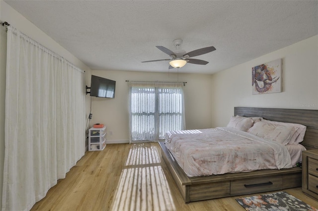2510 Locksley St Unit 2510, Sun City Center, FL 33573 - bedroom with light wood-style flooring, a textured ceiling, and a ceiling fan
