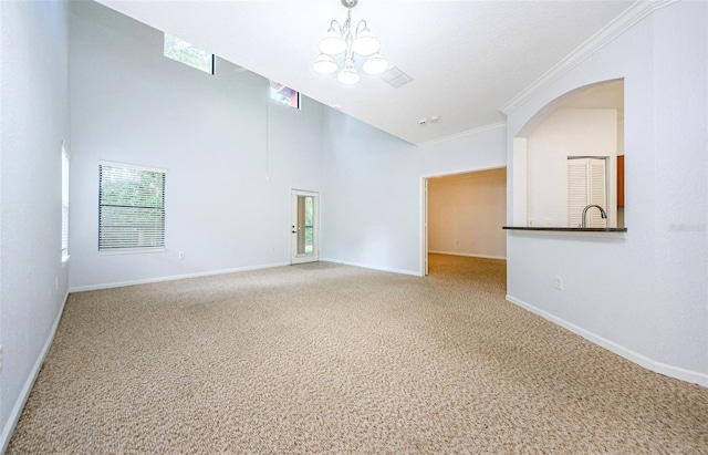 2148 Chianti Pl Unit 1310, Palm Harbor, FL 34683 - unfurnished room featuring carpet flooring, a chandelier, high vaulted ceiling, and arched walkways