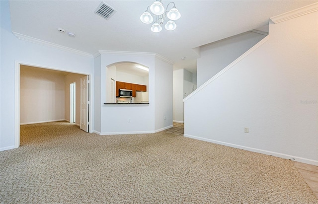 2148 Chianti Pl Unit 1310, Palm Harbor, FL 34683 - unfurnished living room featuring ornamental molding, light colored carpet, stairway, and arched walkways