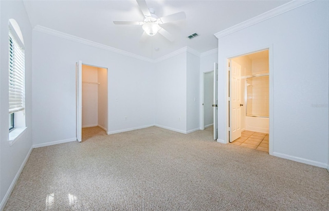 2148 Chianti Pl Unit 1310, Palm Harbor, FL 34683 - unfurnished bedroom featuring carpet, ornamental molding, multiple windows, a ceiling fan, and connected bathroom