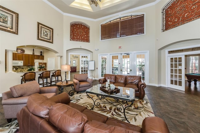 2148 Chianti Pl Unit 1310, Palm Harbor, FL 34683 - living room featuring french doors, a towering ceiling, ornamental molding, ceiling fan, and stone tile floors