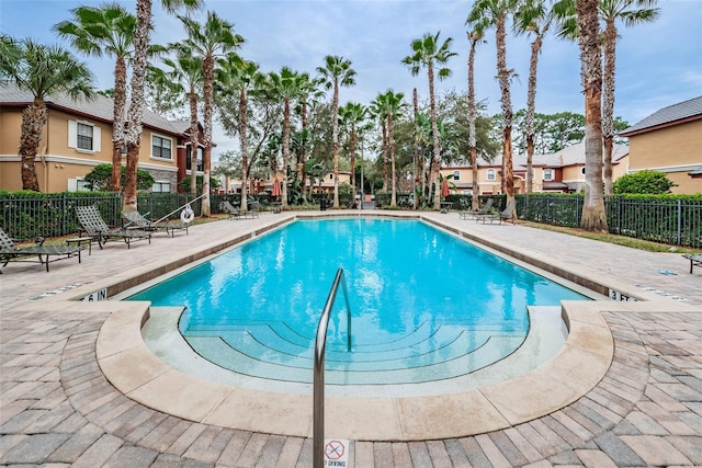 2148 Chianti Pl Unit 1310, Palm Harbor, FL 34683 - community pool featuring a patio and a residential view