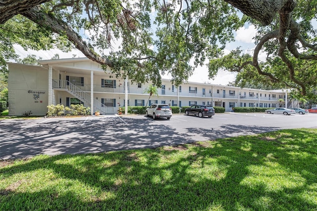 500 Glennes Ln Unit 206, Dunedin, FL 34698 - view of building exterior featuring uncovered parking and stairway