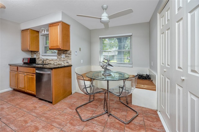 849 Karen St, Palm Harbor, FL 34684 - kitchen with stainless steel dishwasher, backsplash, a ceiling fan, brown cabinets, and light tile patterned floors