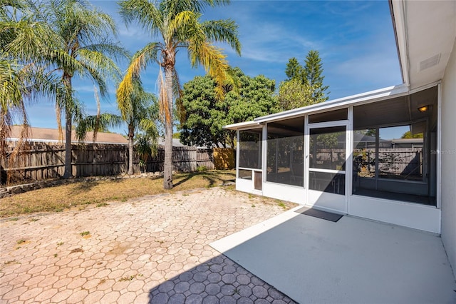 849 Karen St, Palm Harbor, FL 34684 - fenced backyard featuring a sunroom and a patio area