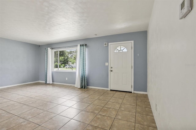 992 20th St SW, Largo, FL 33770 - foyer featuring plenty of natural light, light tile patterned floors, and a textured ceiling