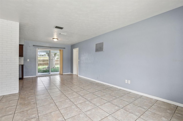 992 20th St SW, Largo, FL 33770 - empty room with light tile patterned floors and a textured ceiling