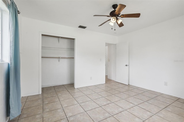 992 20th St SW, Largo, FL 33770 - unfurnished bedroom featuring a closet, ceiling fan, and light tile patterned flooring