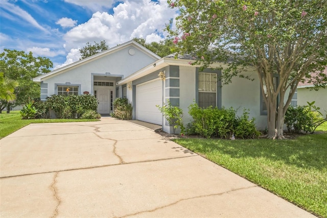 1754 Turtle Rock Dr, Lakeland, FL 33803 - single story home with stucco siding, a garage, a front yard, and driveway