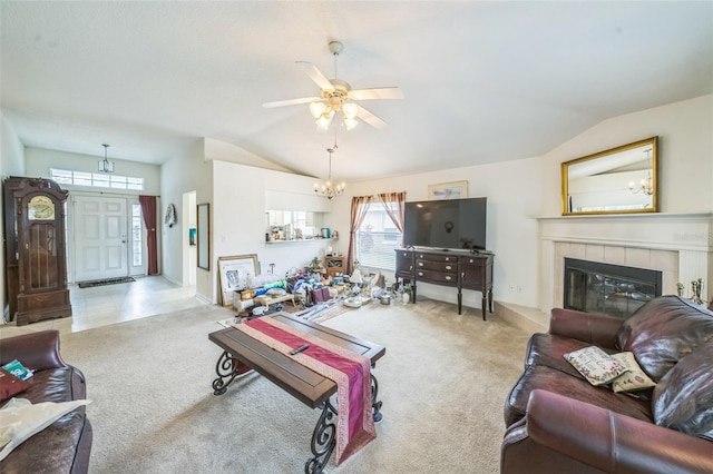 1754 Turtle Rock Dr, Lakeland, FL 33803 - carpeted living area featuring vaulted ceiling, ceiling fan, a tile fireplace, and a chandelier