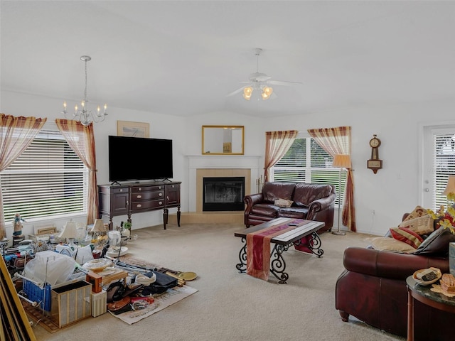1754 Turtle Rock Dr, Lakeland, FL 33803 - carpeted living room featuring a chandelier, plenty of natural light, a tiled fireplace, a ceiling fan, and lofted ceiling