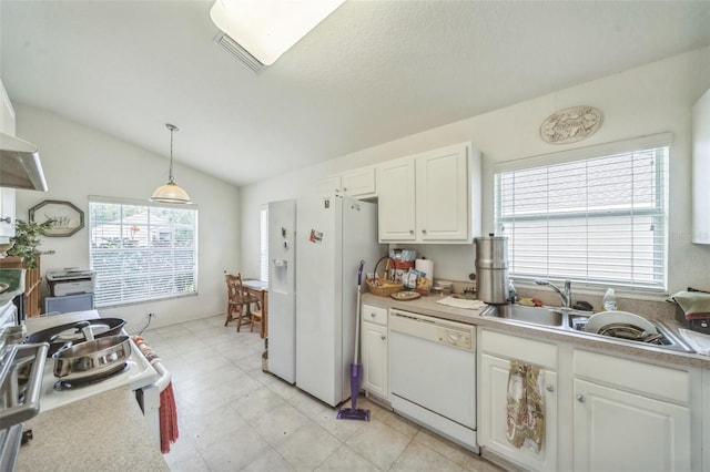 1754 Turtle Rock Dr, Lakeland, FL 33803 - kitchen with white appliances, white cabinetry, hanging light fixtures, lofted ceiling, and light countertops