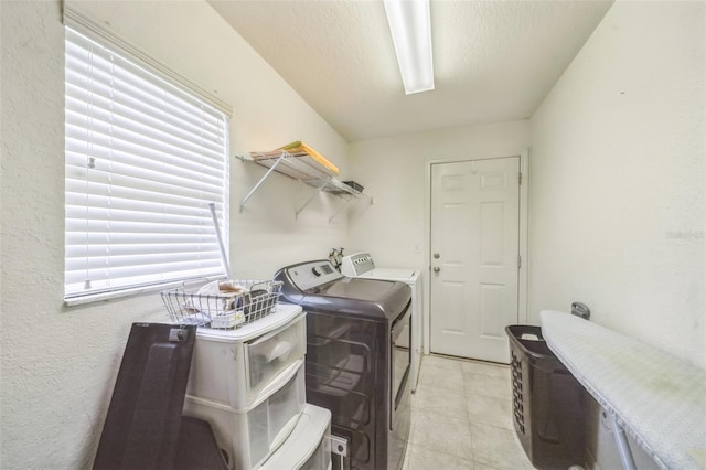 1754 Turtle Rock Dr, Lakeland, FL 33803 - laundry area with washer and clothes dryer and light tile patterned floors