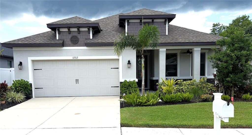 12312 Rose Haven Blvd, New Port Richey, FL 34654 - view of front of property featuring a shingled roof, concrete driveway, a garage, and a front lawn