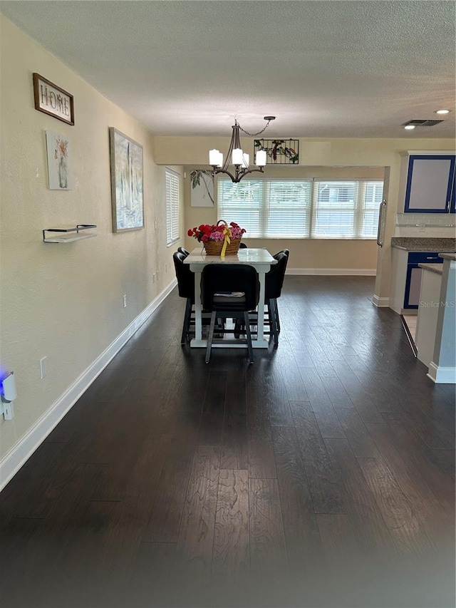 3260 Parkway Pl, Palm Harbor, FL 34684 - dining room with a chandelier, healthy amount of natural light, dark wood-style flooring, and a textured ceiling
