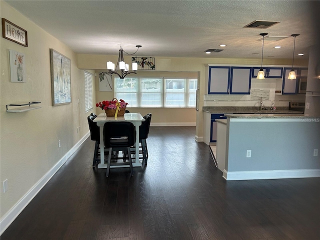 3260 Parkway Pl, Palm Harbor, FL 34684 - dining space featuring a chandelier, dark wood-style floors, a textured ceiling, and recessed lighting