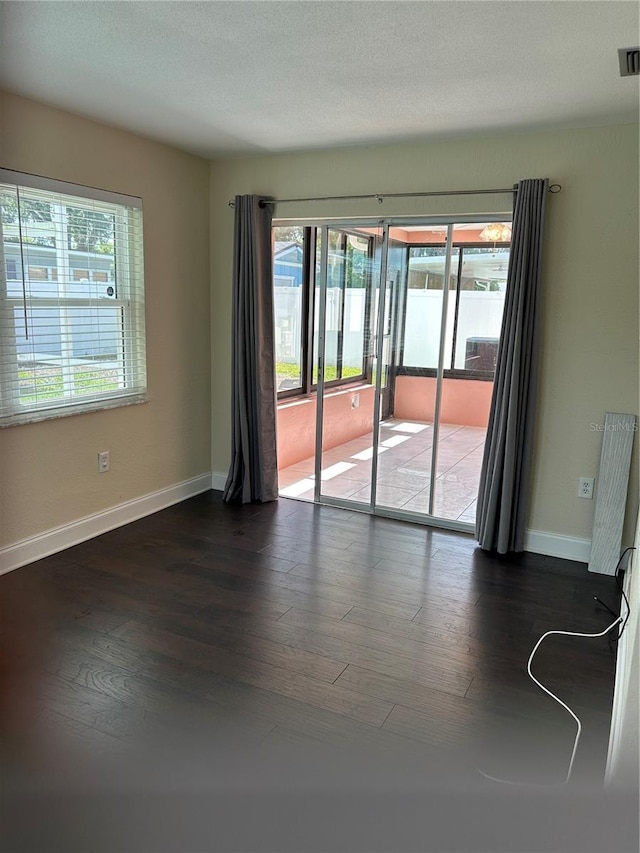 3260 Parkway Pl, Palm Harbor, FL 34684 - empty room featuring healthy amount of natural light and wood finished floors