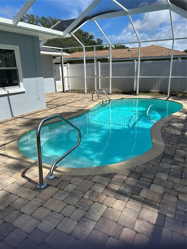 3260 Parkway Pl, Palm Harbor, FL 34684 - swimming pool featuring glass enclosure and a patio